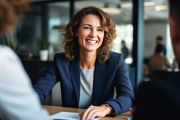 Happy mid aged business woman manager at the meeting